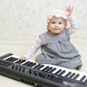 Baby girl posing with Electronic piano