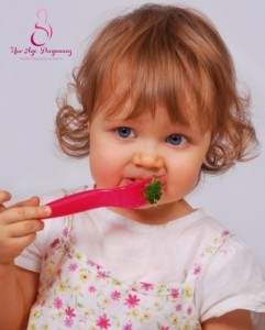 baby eating broccoli