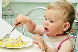 baby eating potato